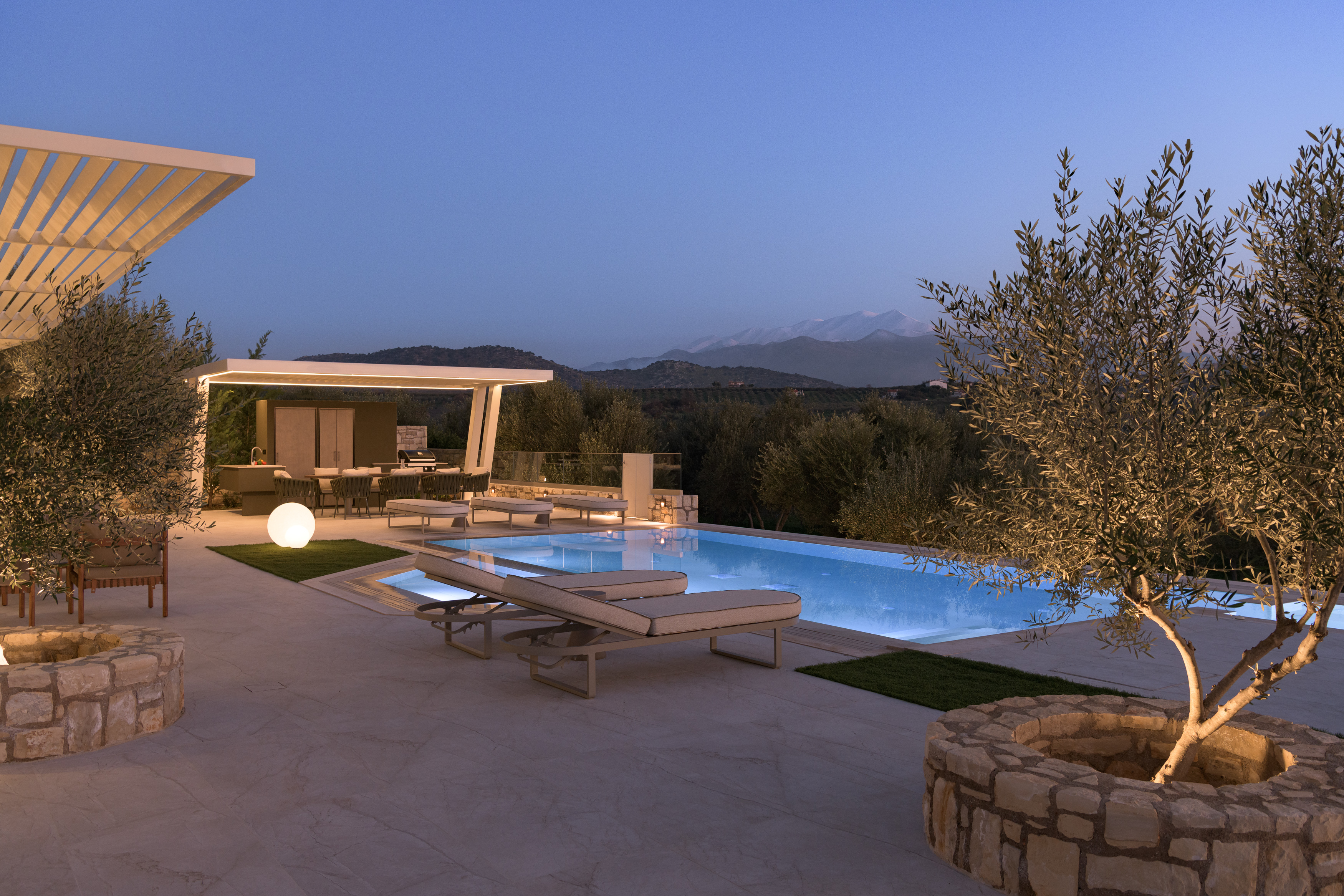 Experience serenity as the pool shimmers under the night sky.