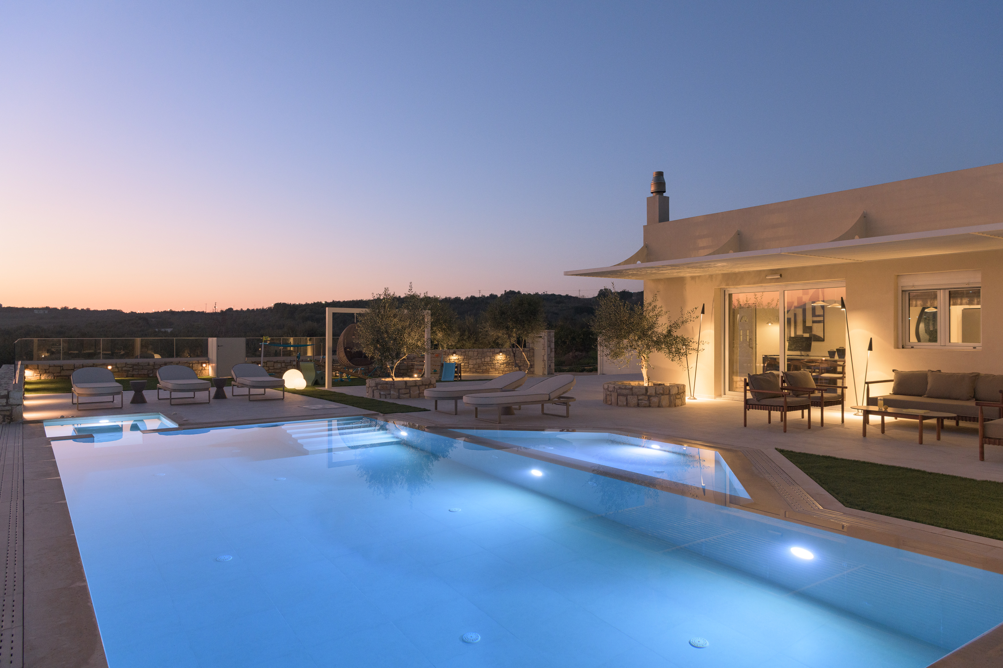 Experience the villa's enchanting ambiance as it transforms under the night sky.