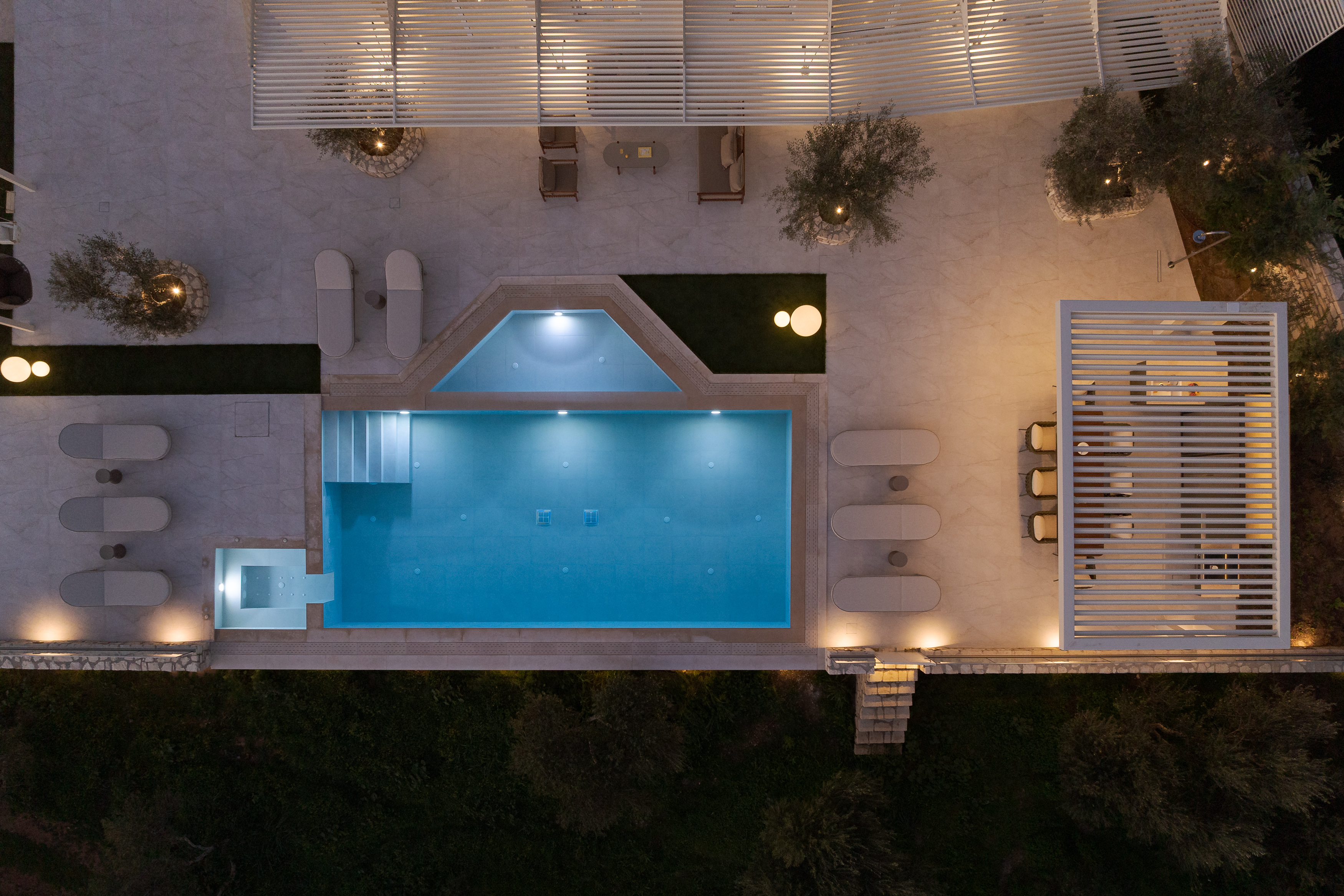 A mesmerizing aerial view of the pool terrace at night.