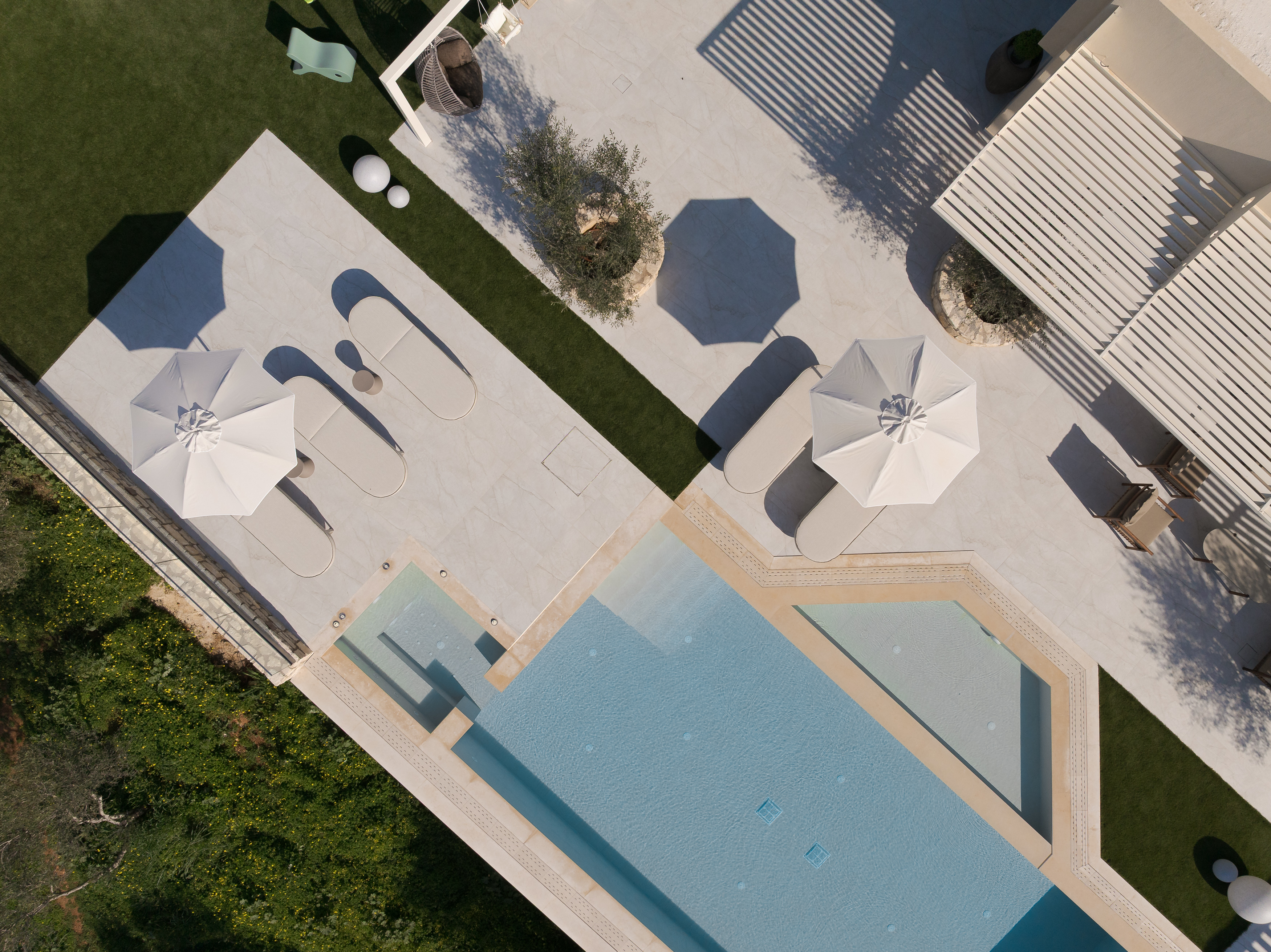 Bird's Eye View from the outdoor pool surroundings featuring bespoke sunloungers and umbrellas.