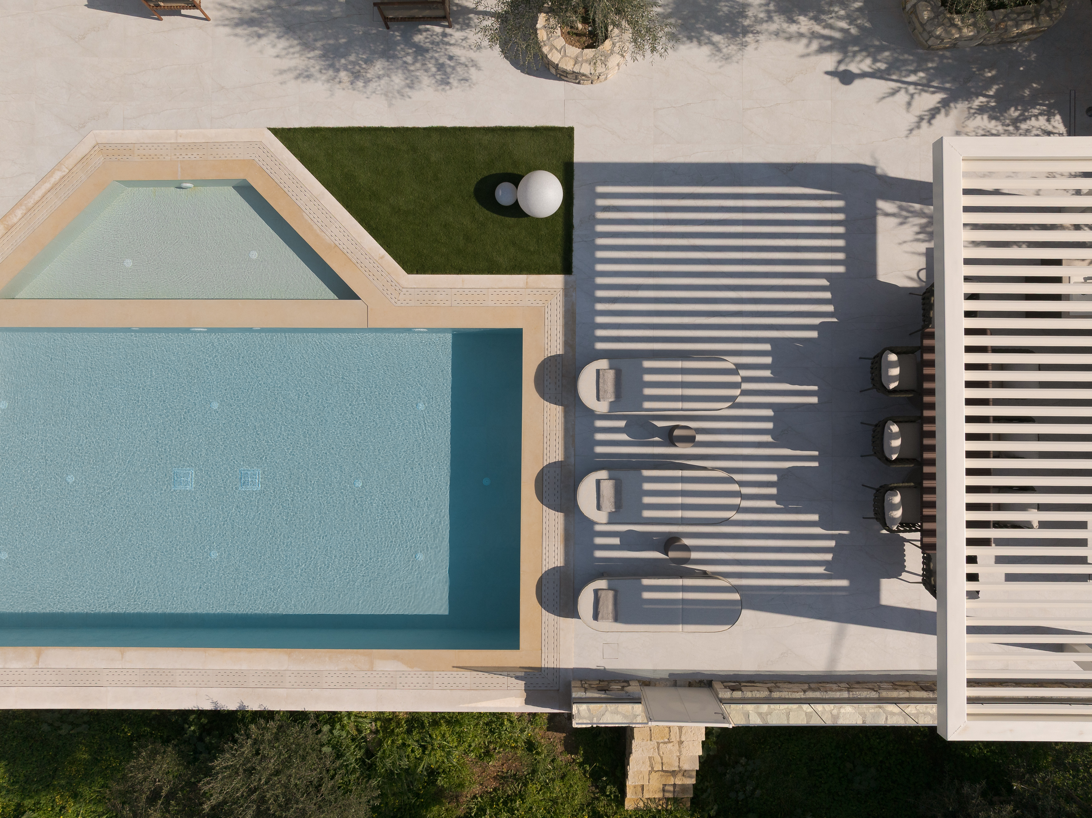 Bird's Eye View from the outdoor pool surroundings featuring bespoke sunloungers and umbrellas.