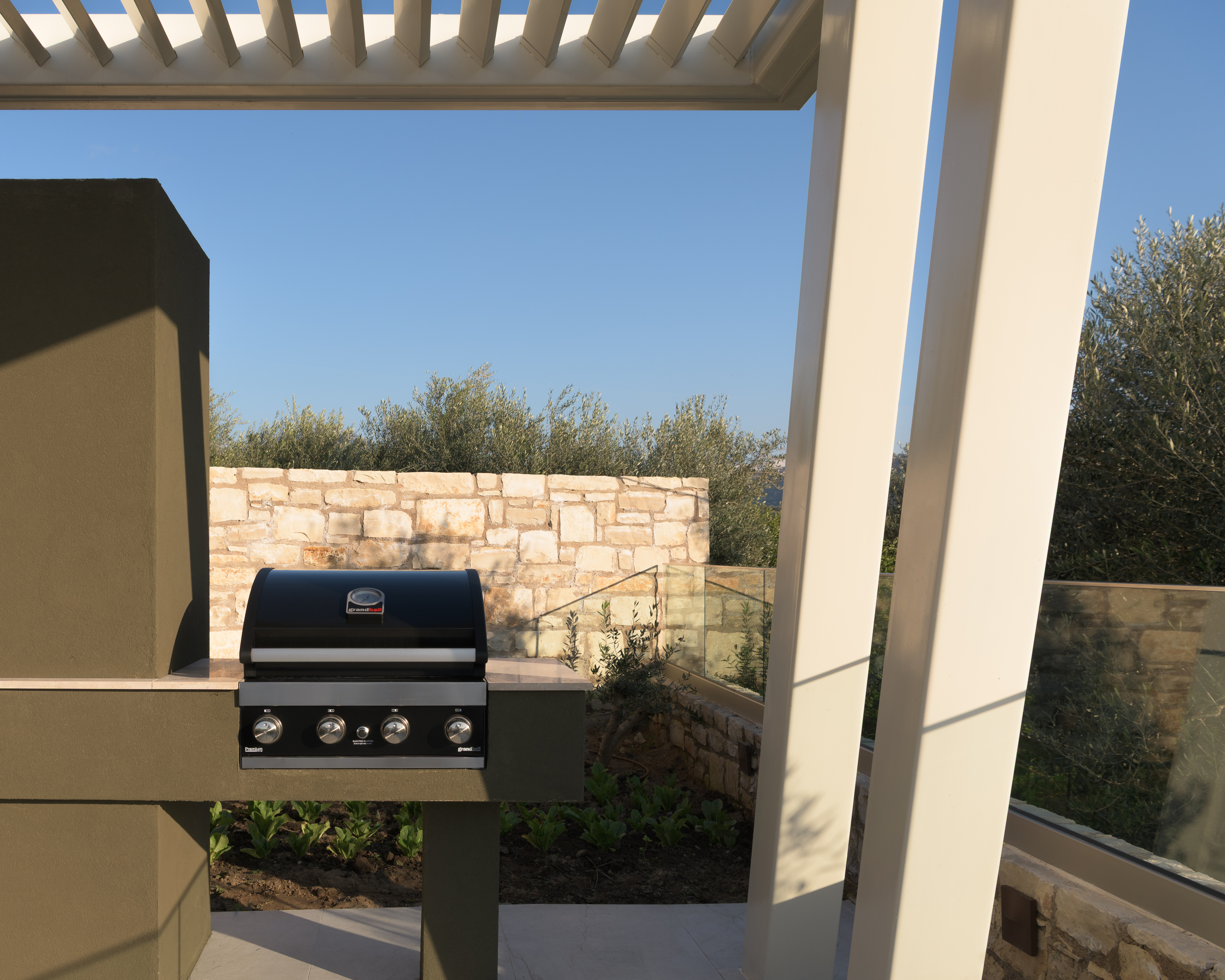Dine alfresco in a setting of refined tranquility, featuring a Gas BBQ.